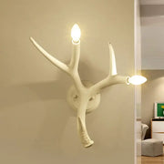 Contemporary white resin antler shaped wall sconce with two illuminated bulbs designed for dining rooms and restaurants