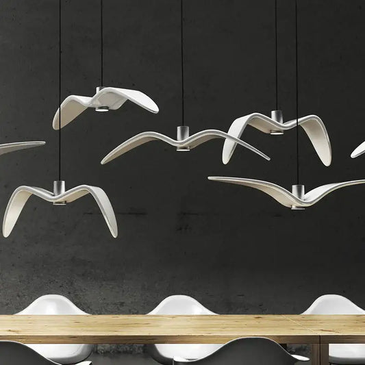 Contemporary white seagull pendant light with metallic fixtures and inviting glow for modern dining room design