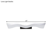 Contemporary white wave shaped 23 inch led wall mounted light with black base ideal for bathroom lighting