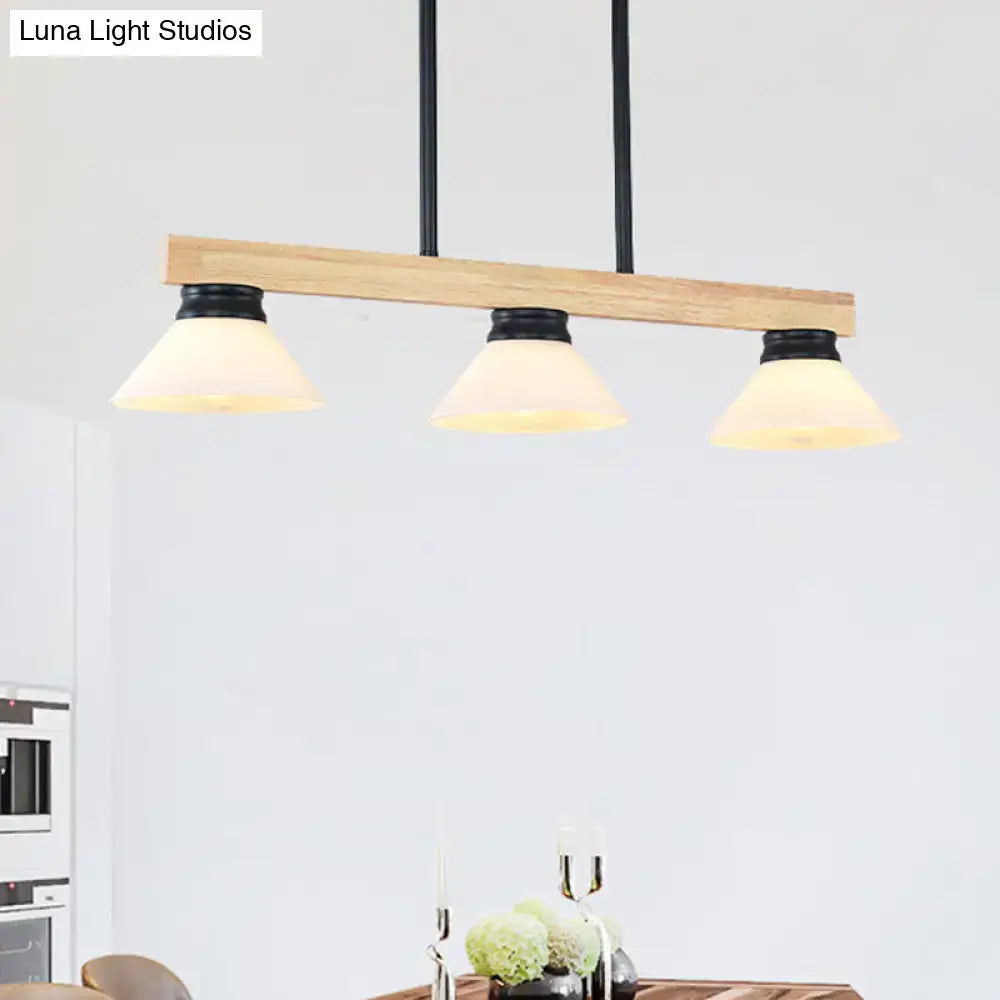 Modern farmhouse-style linear island ceiling light with natural wood bar, black metal rods, and frosted glass shades gold black