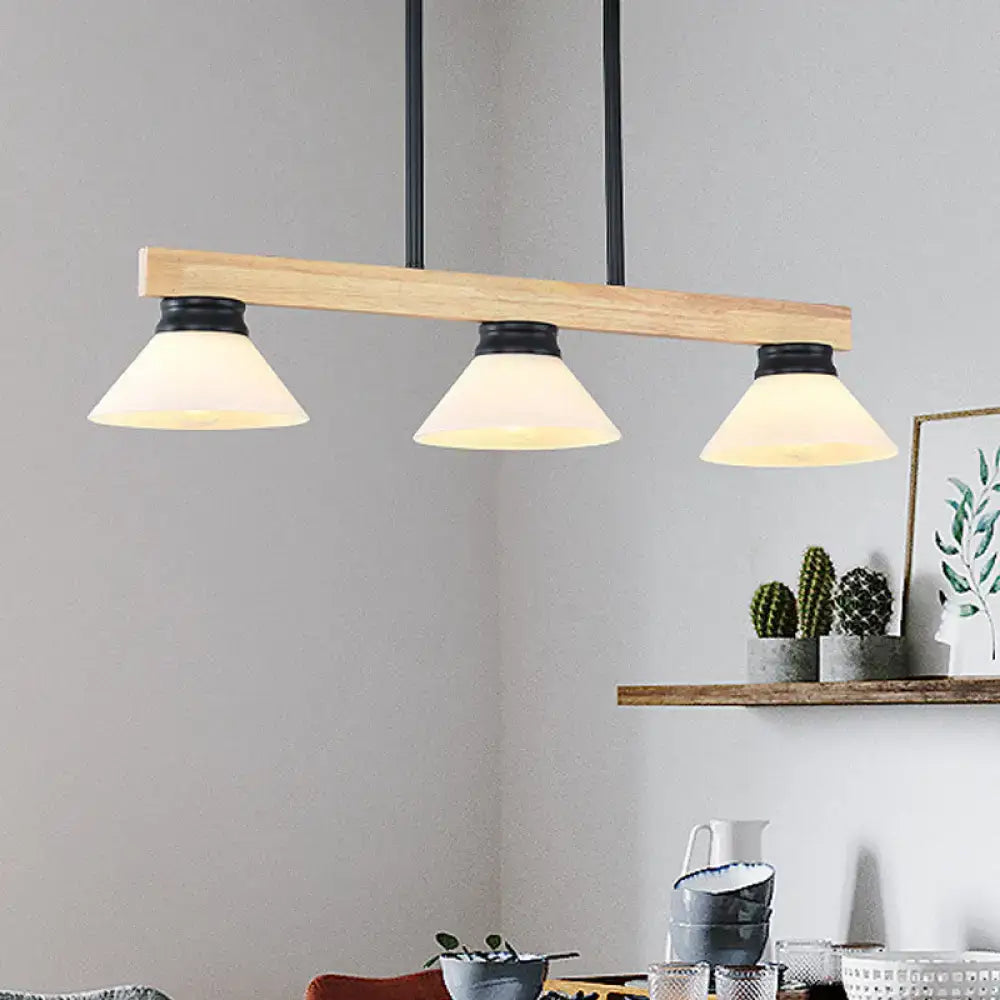 Contemporary wood linear island ceiling light with gold black metal hardware and frosted glass shades in dining room