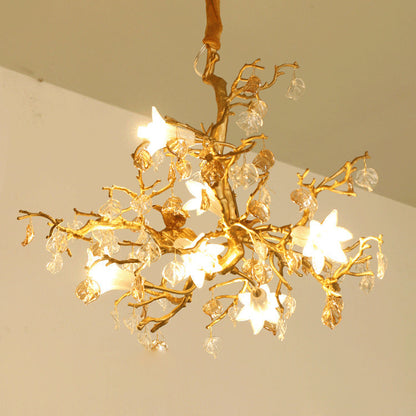 Gold tree branch chandelier with crystal accents and star-shaped lights.
