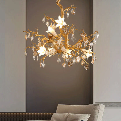 Gold floral chandelier with crystal accents and white flowers.