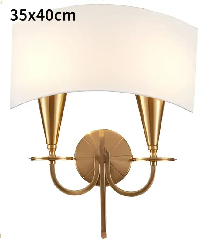 Gold-toned wall sconce with two conical arms and off-white fabric shade for decorbites copper ceiling chandelier collection