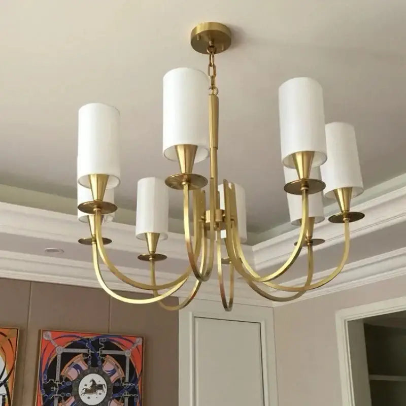 Gold-toned copper ceiling chandelier with five white fabric cylindrical shades for living room decor by decorbites copper ceiling