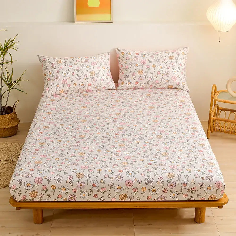 Pastel floral fitted sheet set featuring green leaf flower accents on a soft white background for bedroom bedding