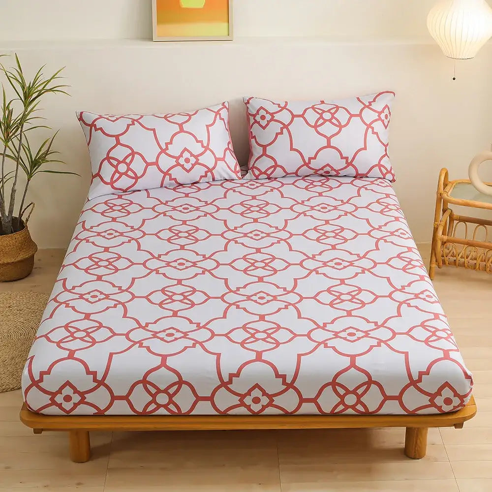 White fitted sheet set with coral red geometric floral pattern featuring interconnected green leaf flower shapes