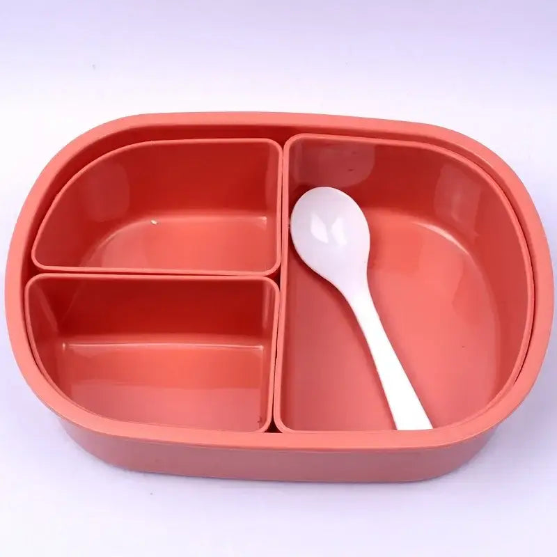 Coral and white lunch box set featuring a coral plastic three compartment bento box with a white spoon included