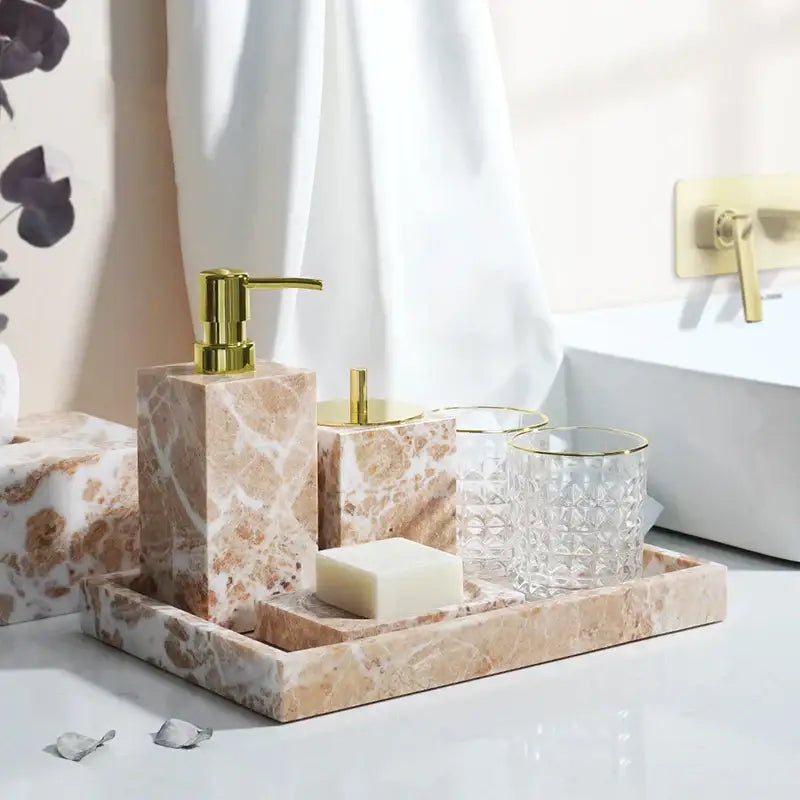 Coral pink marble bathroom accessories set with gold-tone accents and clear glass cups by decorbites coral pink