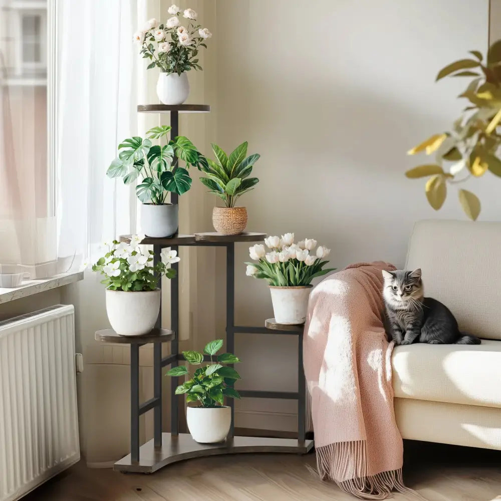 Dark metal decorbites™ 6-tier corner plant stand with multiple tiers holding potted plants in white and woven pots