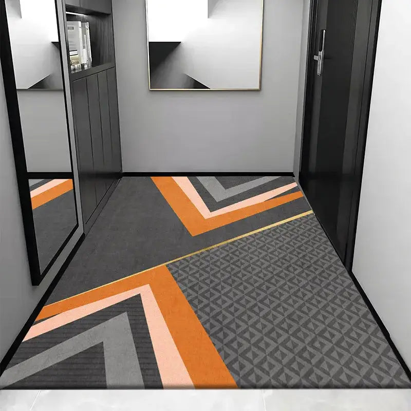 Modern geometric-patterned cosmic grey crystal velvet entrance rug featuring bold orange gray and black chevron stripes
