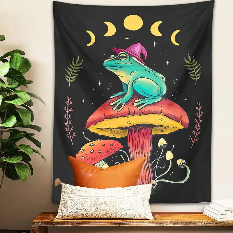 Cottagecore frog on mushroom tapestry wall hanging featuring a teal decorbites frog on a red and yellow mushroom with moon phases