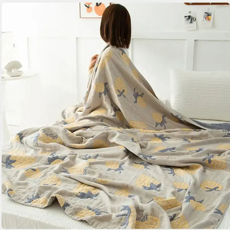 Beige cotton gauze boho throw blanket with playful yellow and gray pineapple pattern for cozy decorbites cotton gauze use