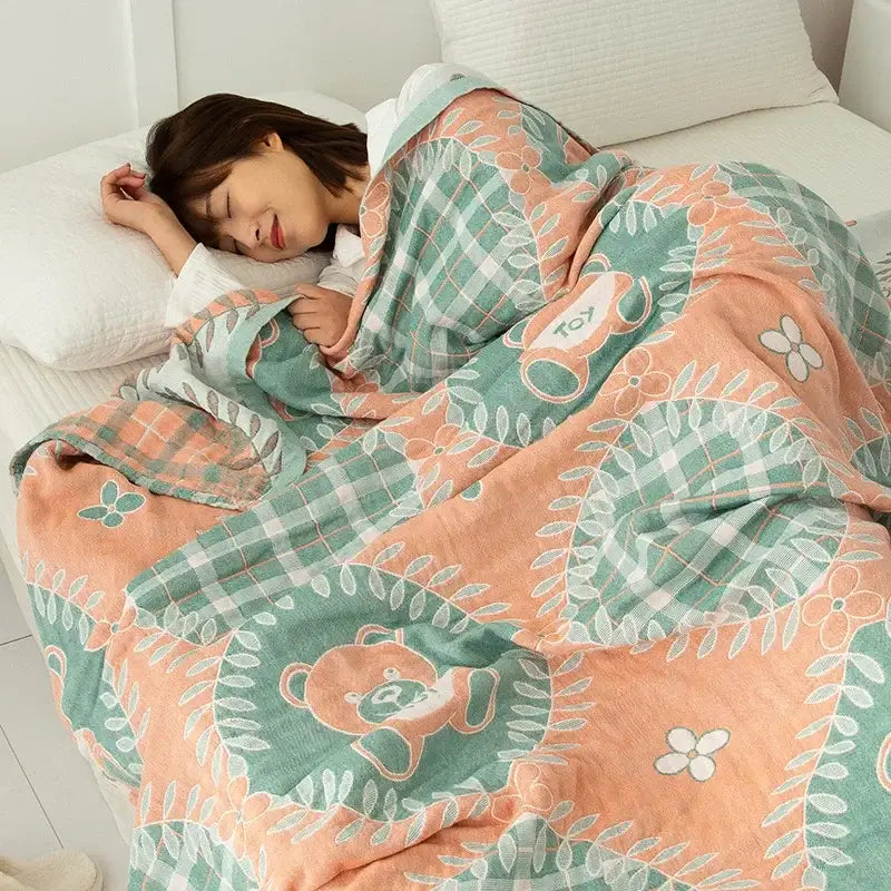 Soft peach and mint green cotton gauze boho throw with embroidered bear motifs for cozy bedroom decorbites cotton gauze