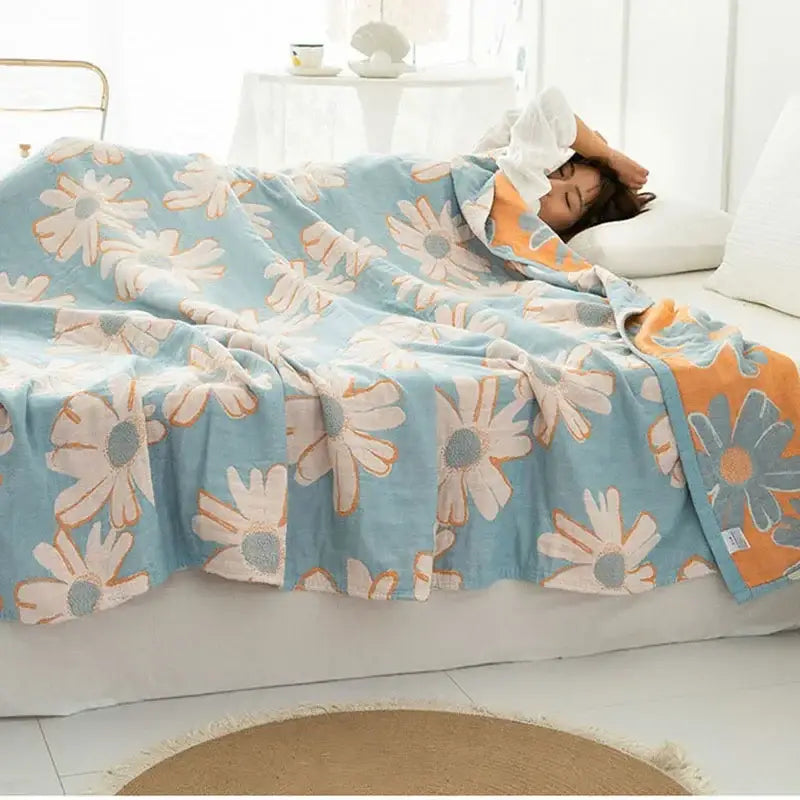 Cotton gauze boho throw light blue blanket with cheerful white and orange daisy pattern for stylish decorbites cotton gauze decor