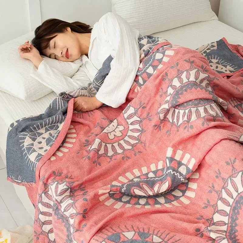 Soft pink and gray patterned fleece blanket with intricate floral designs in decorbites cotton gauze boho throw style