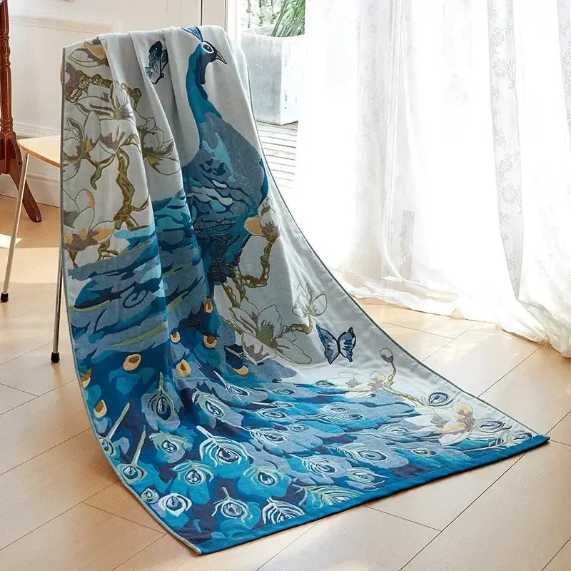 A plush light blue cotton gauze peacock bath towel with intricate feather and butterfly motifs by decorbites cotton gauze