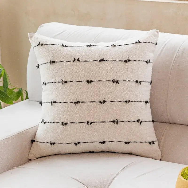 Cream-colored cotton stripe jacquard cushion with black horizontal stripes and tassel accents for living room decorbites cotton stripe