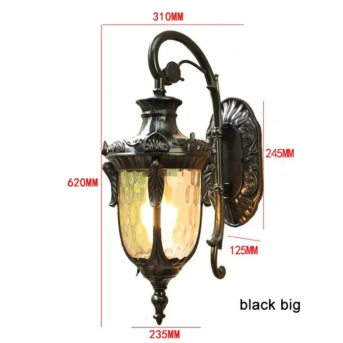 Black ornate wrought iron outdoor wall lantern with textured amber glass shade for country restaurant lighting