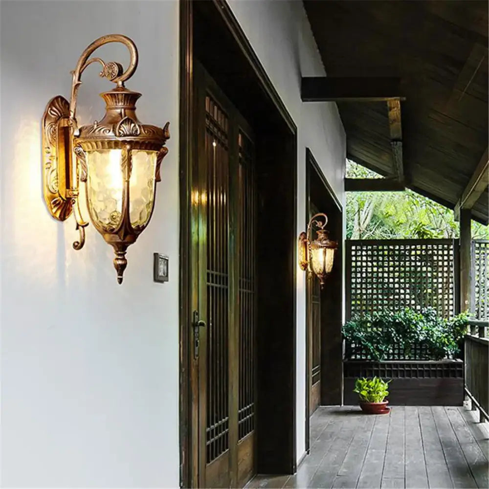 Antique brass wall sconce with textured amber glass shade for country black wrought iron outdoor wall lantern use
