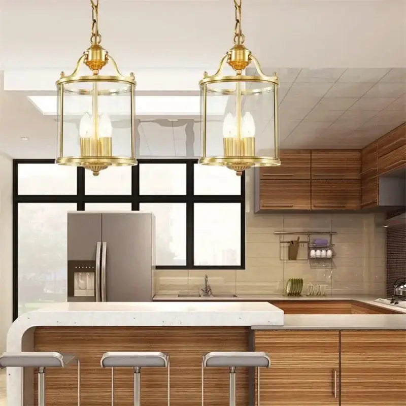 Pair of decorbites bronze glass pendant lights with clear enclosures and three exposed bulbs for dining room decor