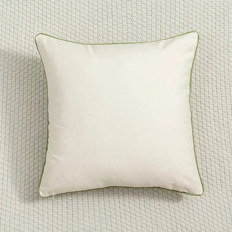 Cream-colored country floral embroidered cushion cover with subtle olive green piping for living room use