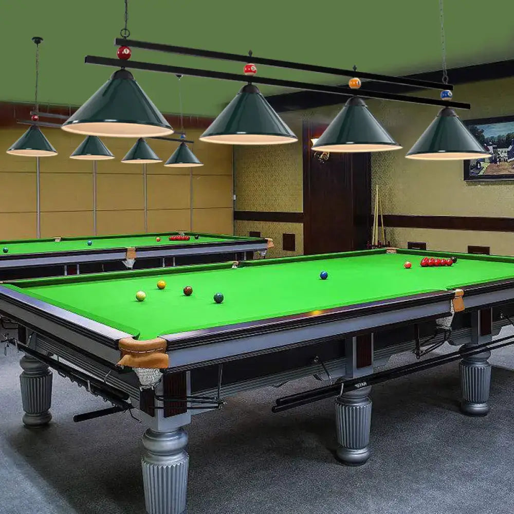 Elegant silver-finished pool table with green felt and ornate legs under country style dark green bar island lighting fixture