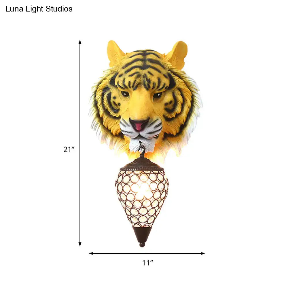 Country tiger head wall sconce in yellow with black stripes featuring an ornate brown metal lantern and clear crystal shade wall lamp