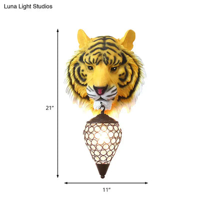 Country tiger head wall sconce in yellow with black stripes featuring an ornate brown metal lantern and clear crystal shade wall lamp