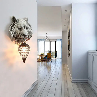 Country tiger head wall lamp with grayish-white sculpted tiger head and ornate black lantern featuring a clear crystal shade