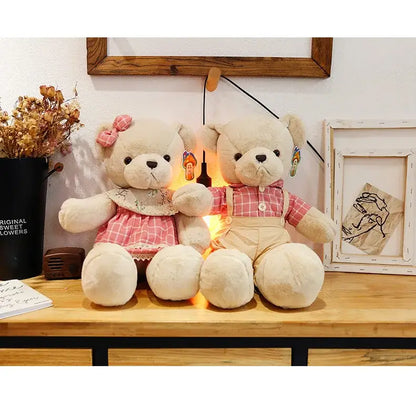Two cream-colored plush toys from decorbites featuring a couple bear plush dressed for christmas gift giving