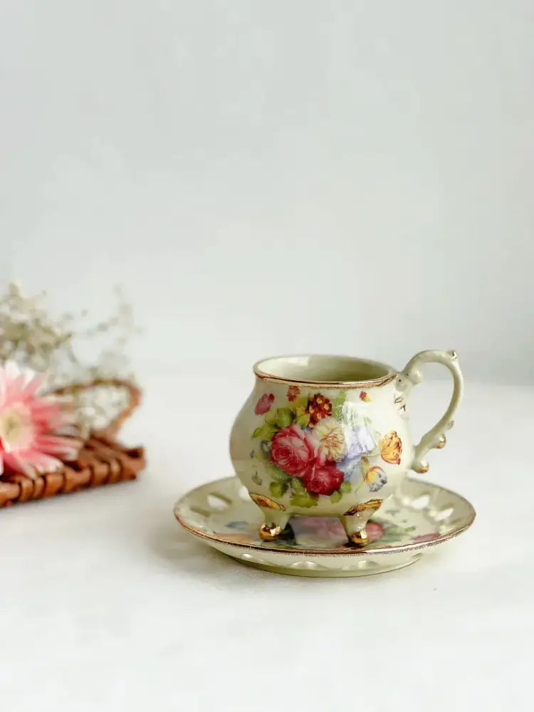 Delicate porcelain cup set with court style floral design pastel hues gold trim and ornate feet for decorbites court style dining room