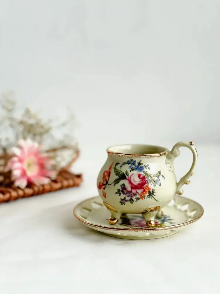 A delicate cream porcelain cup set with gold handle and intricate floral patterns for decorbites court style dining room