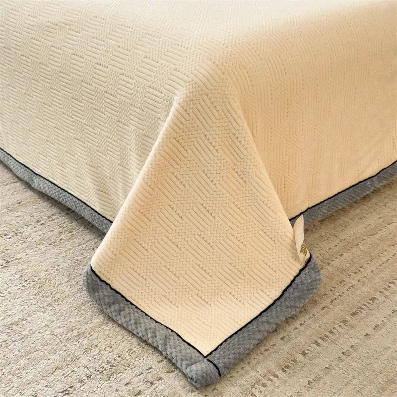 Beige textured bedspread with gray plush border and subtle woven pattern for decorbites cozy carved velvet throw