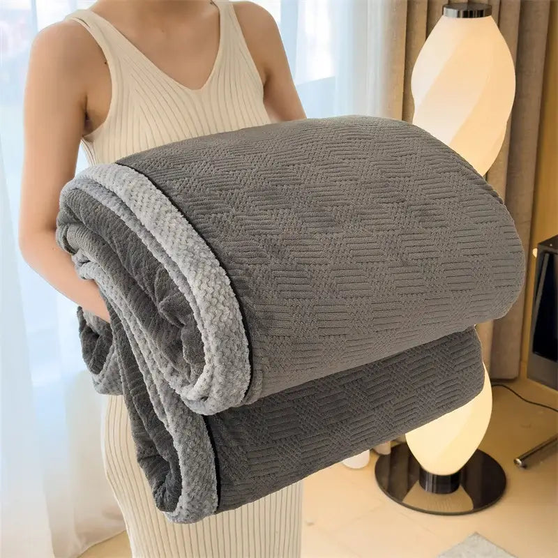 A plush double-sided gray throw blanket with textured woven pattern and soft fleece lining from decorbites cozy carved velvet collection
