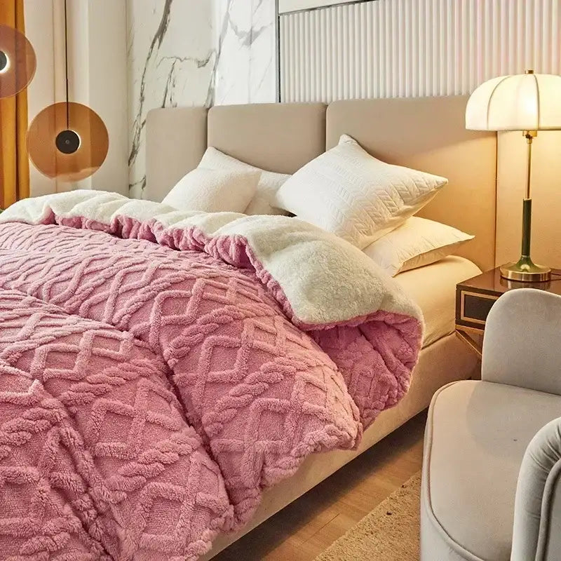 Pink plush quilt with textured diamond pattern and soft white fleece lining for cozy cashmere blanket duvet cover