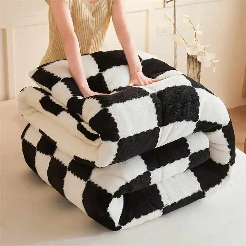 A plush black and white decorbites cozy checkerboard winter blanket with soft fluffy texture for bedroom comfort