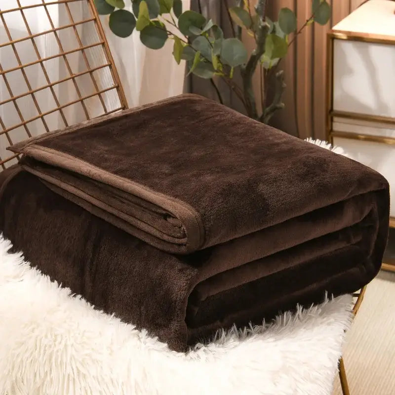 A plush deep brown fleece blanket with soft velvety texture and neatly folded edges from decorbites cozy checkered collection