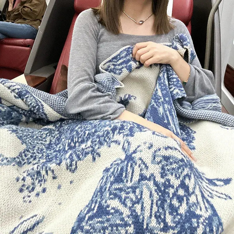 A cozy chinese ink blue and white toile knit blanket in cream and deep blue with an intricate floral pattern