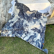 Blue and white patterned throw blanket with chinese ink knit toile design featuring animals and tassels for decorbites cozy chinese decor