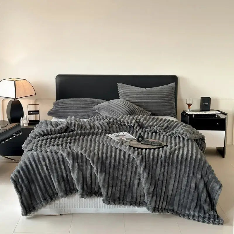 Plush gray corduroy throw blanket with soft textured surface and ribbed vertical stripes for cozy coral fleece decorbites