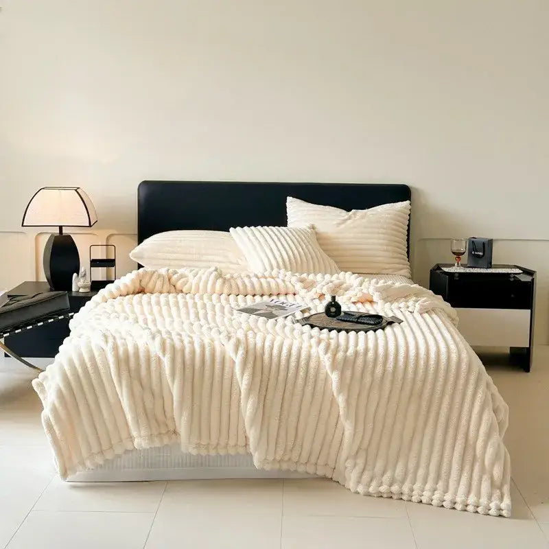 Cream-colored ribbed fleece blanket with plush textured surface by decorbites cozy coral fleece for living room decor
