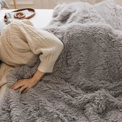 A cozy faux fur throw blanket in gray with soft shaggy texture perfect for decorbites cozy faux decor in pink bedroom