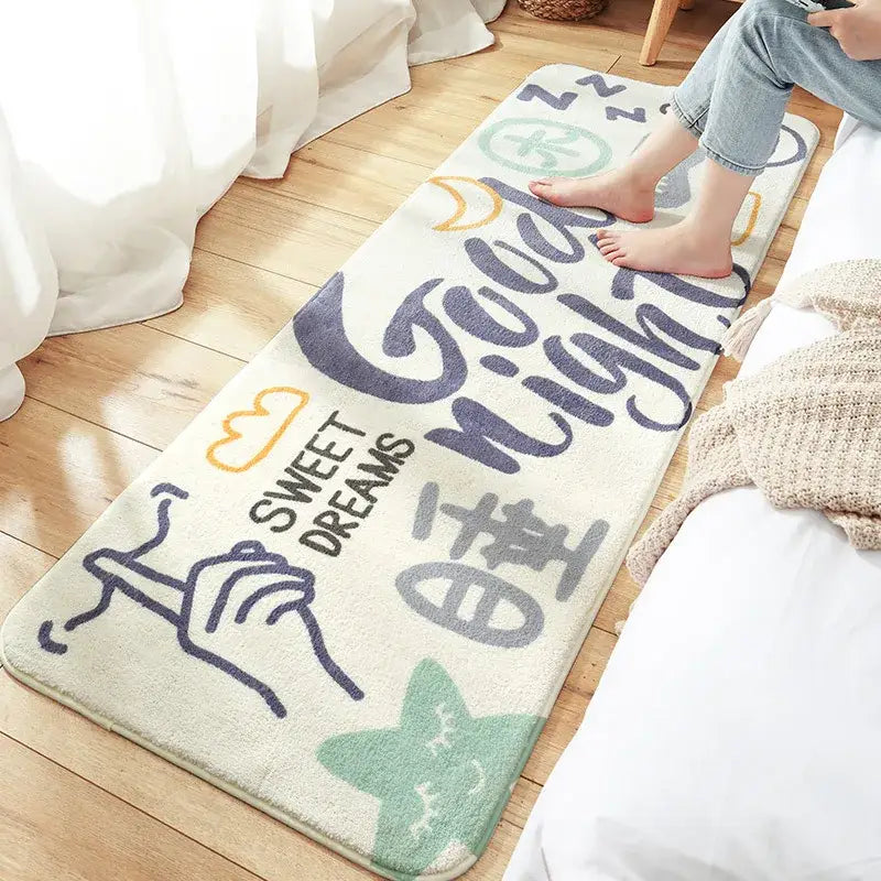 Cream-colored decorbites cozy faux lamb bedside rug with navy script good night design and colorful cloud star accents