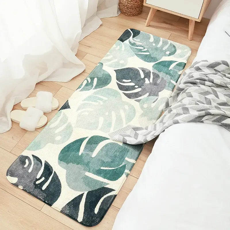 Cozy faux lamb plush bedside rug with a watercolor monstera leaf pattern in green and gray on an off-white background