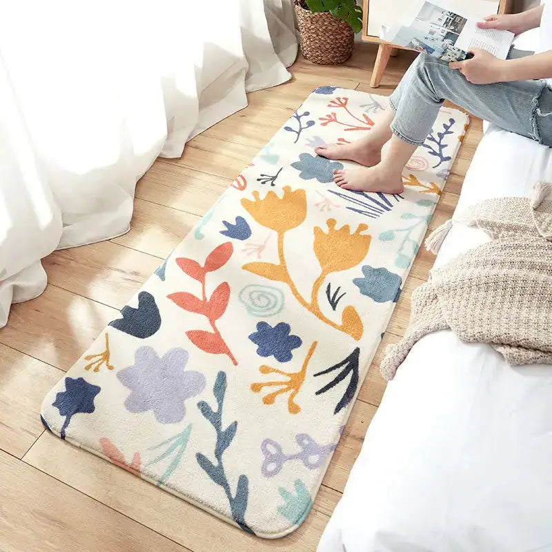 A cream-colored cozy faux lamb wool bedside rug with a playful orange blue purple and teal floral pattern