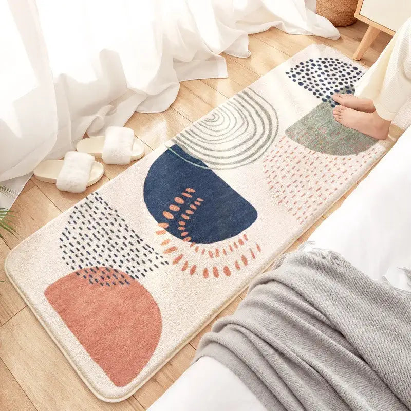 A cream-colored decorbites cozy faux lamb wool bedside rug with navy, terracotta, and green geometric patterns