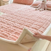 Pink quilted mattress pad with cozy faux rabbit fur white fleece border and soft textured surface decorbites cozy faux