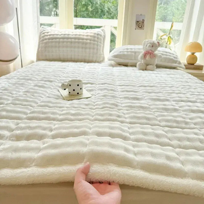 Cream-colored plush quilted bedspread with soft textured surface and fluffy edge cozy faux rabbit fur decorbites