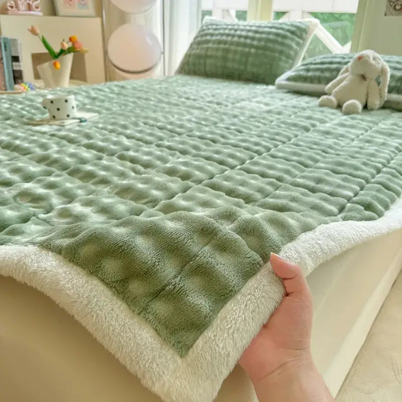 Soft mint green quilted bedspread with plush white fleece border featuring decorbites cozy faux rabbit fur design